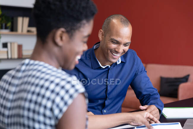 Diverse business people sitting going through paperwork in a modern office. business modern office workplace technology. — Stock Photo