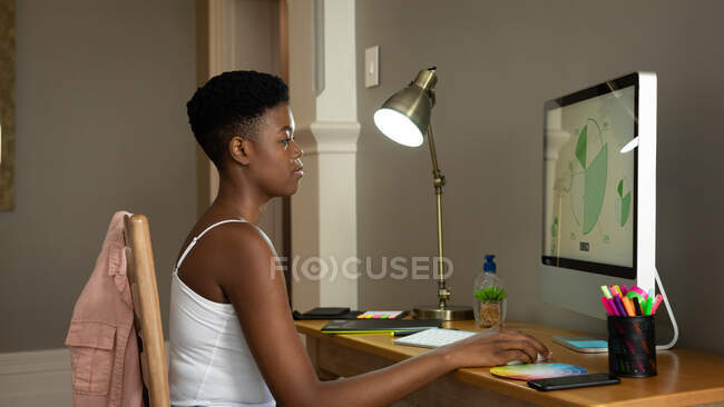 African american woman using computer while working from home. staying at home in self isolation in quarantine lockdown — Stock Photo