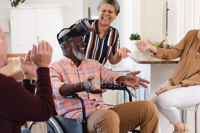 Senior caucasian and african american couples sitting on couch using vr headset at home. senior retirement lifestyle friends socializing. — Stock Photo