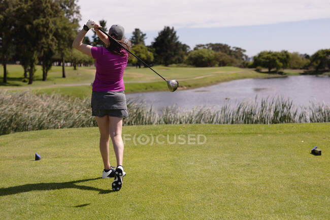 Caucasian woman playing golf swinging club and taking a shot. sport leisure hobbies golf healthy outdoor lifestyle. — Stock Photo