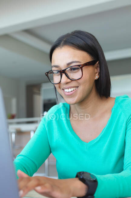 African american woman using laptop while working from home. staying at home in self isolation in quarantine lockdown — Stock Photo