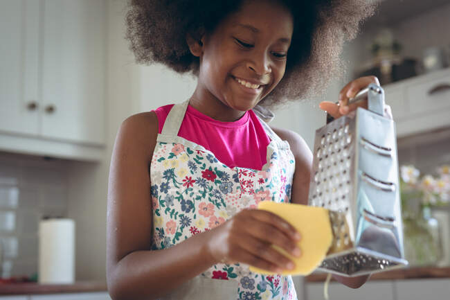 African american girl making pizza together in kitchen. staying at home in self isolation during quarantine lockdown. — Stock Photo