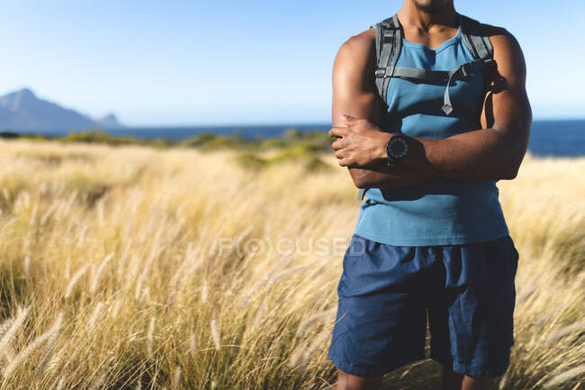 Midsection of fit african american man exercising outdoors to camera. fitness training and healthy outdoor lifestyle. — Stock Photo