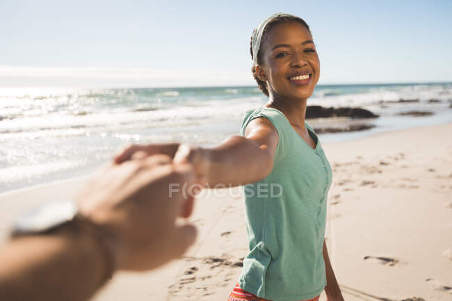 Glückliches afrikanisch-amerikanisches Paar am Strand Händchen haltend. gesunde Freizeit im Freien am Meer. — Stockfoto