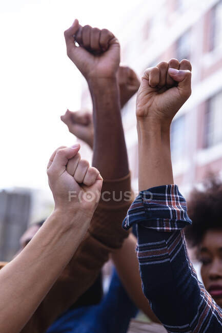 Raised fists of diverse male and female protesters demonstrating on march. equal rights and justice demonstration march. — Stock Photo