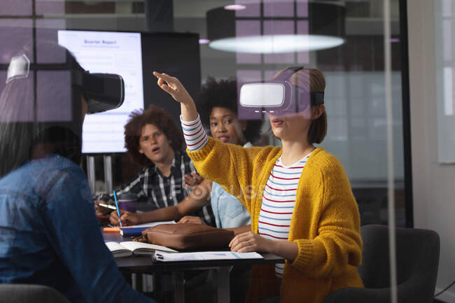 Diverse group of creative colleagues using vr headset in meeting room. independent creative design business. — Stock Photo