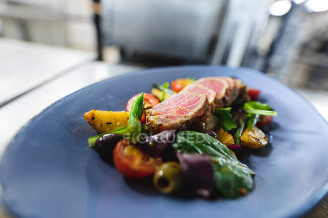 Close up of ready to serve dish prepared by professional chef. working in a busy restaurant kitchen. — Stock Photo