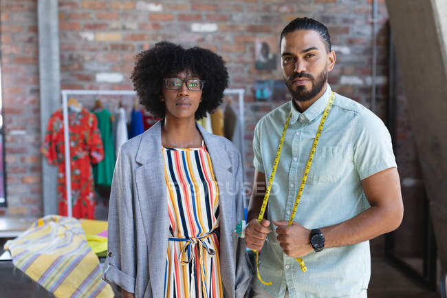 Portrait of diverse male and female designers looking at camera. independent creative fashion design business. — Stock Photo