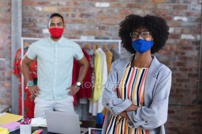 Portrait of diverse male and female designers looking at camera. independent creative fashion design business during coronavirus covid 19 pandemic — Stock Photo