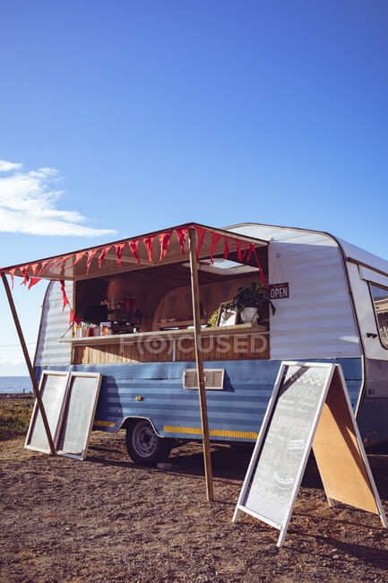 General view of food truck by seaside on sunny day. independent business and street food service concept. — Stock Photo