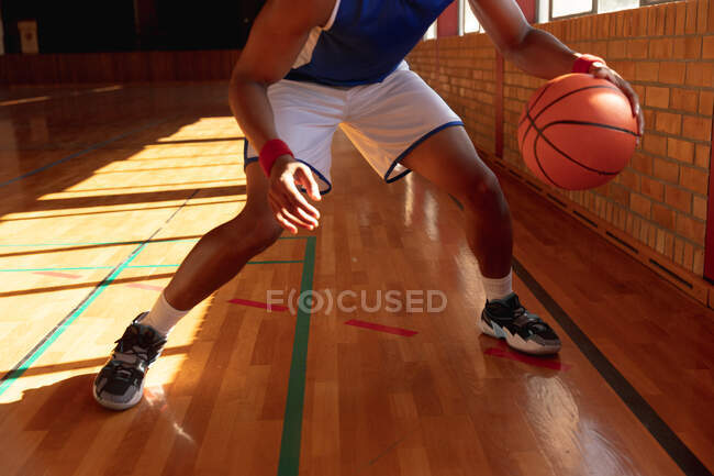 Male basketball player wearing blue sportswear and practice dribbling ball. basketball, sports training at an indoor court. — Stock Photo