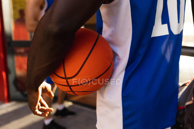 Male basketball player wearing blue sportswear and holding ball. basketball, sports training at an indoor court. — Stock Photo