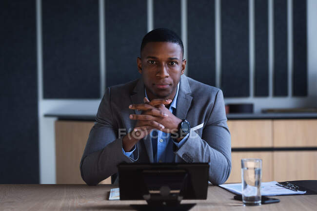 Portrait of african american businessman sitting in meeting room at modern office. business and office concept — Stock Photo