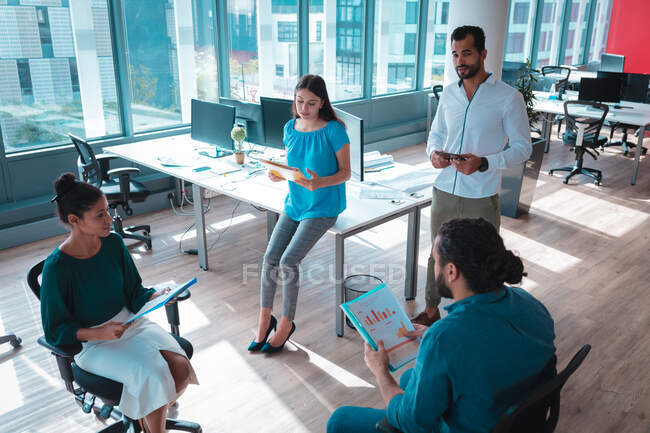 Group of diverse businesspeople discussing together and holding documents. work at an independent creative business. — Stock Photo