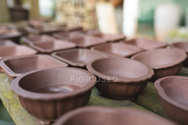 Various empty pots prepared for planting at garden centre. specialist bonsai plant nursery, independent horticulture business. — Stock Photo