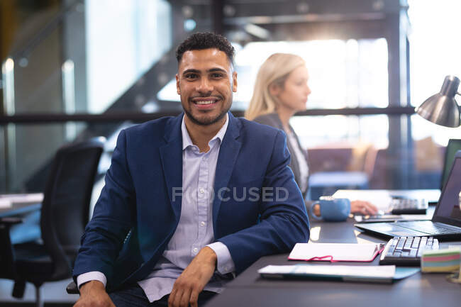 Portrait of businessman with female business colleague working at desk using laptop. working in business at a modern office. — Stock Photo