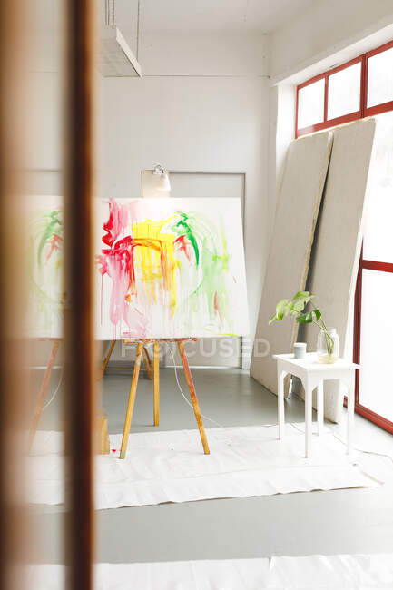 Modern abstract oil painting on canvas sitting on easel in artists studio. creation and inspiration at an artists painting studio. — Stock Photo