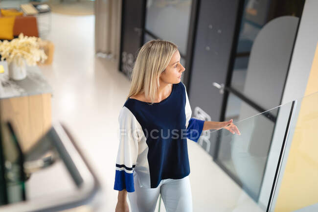 Caucasian businesswoman wearing formal clothes, thinking and looking away. working in business at a modern office. — Stock Photo