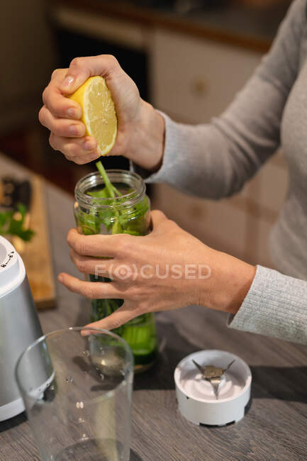 Close up of woman in kitchen, preparing health drink. domestic lifestyle, enjoying leisure time at home. — Stock Photo