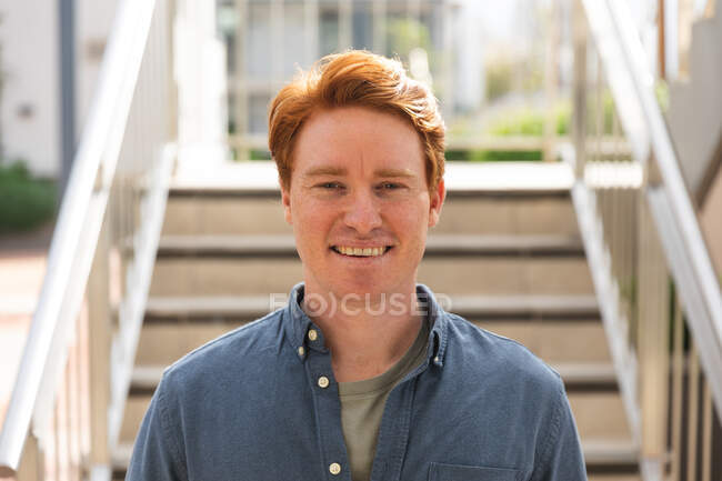 Smiling caucasian male business creative looking at camera outside workplace. independent creative business people working at a modern office. — Stock Photo