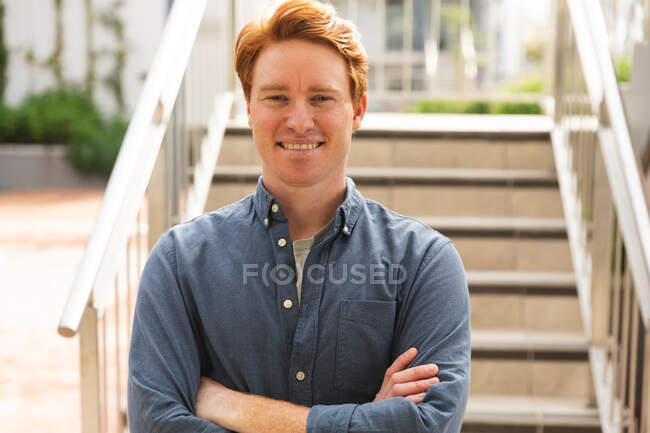 Smiling caucasian male business creative looking at camera outside workplace. independent creative business people working at a modern office. — Stock Photo