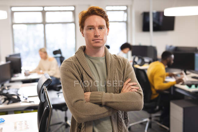 Portrait of caucasian male creative at work, looking to camera. working in creative business at a modern office. — Stock Photo