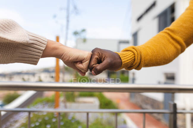 Diverse male and female colleagues at work, fist bumping. working in creative business at a modern office. — Stock Photo