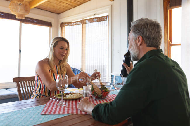 Feliz casal maduro caucasiano ter um jantar romântico em casa. desfrutar de tempo de lazer em casa. — Fotografia de Stock