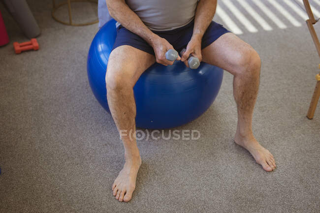 Male physiotherapist treating back of senior male patient at clinic. senior healthcare and medical physiotherapy treatment. — Stock Photo