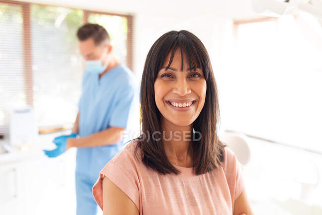 Portrait of smiling caucasian female patient looking at camera at modern dental clinic. healthcare and dentistry business. — Stock Photo