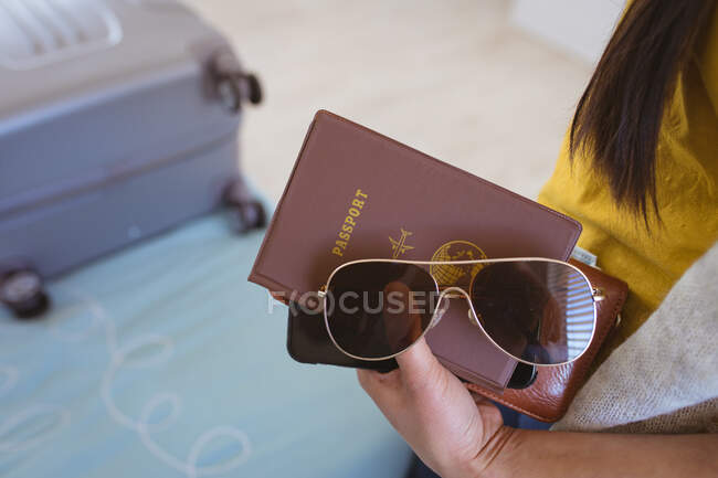 Hands of woman preparing documents and glasses for travel. travel preparation during covid 19 pandemic. — Stock Photo