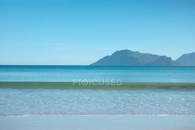 Malerischer Blick auf das Meer mit Bergen in der Ferne vor klarem blauen Himmel und kopieren Raum. Natur und Ruhe. — Stockfoto