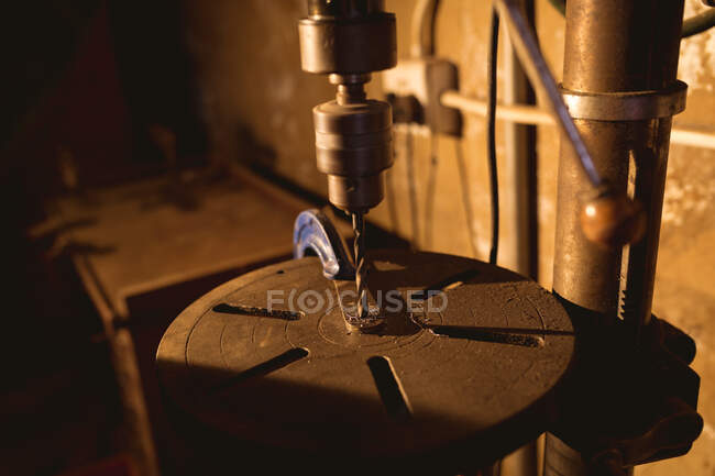 Close-up of drill making hole on metal in manufacturing industry. forging, metalwork and manufacturing industry. — Stock Photo
