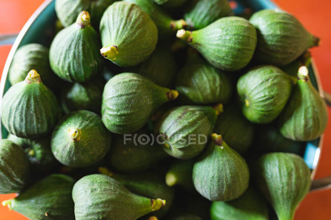 Overhead view of fresh healthy fig pile in container at kitchen counter. organic and healthy eating. — Stock Photo
