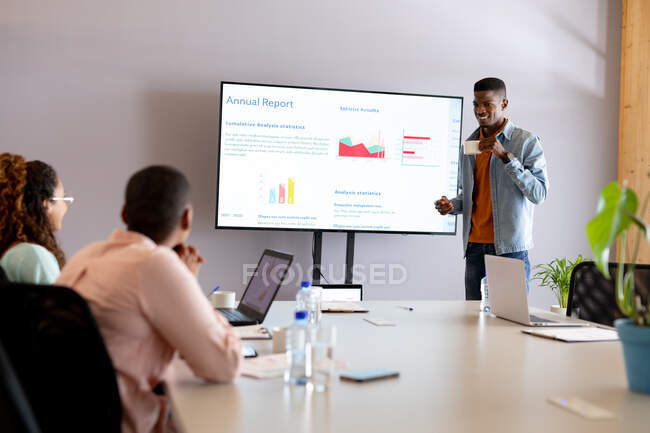 African american young businessman in casuals giving presentation in board room at creative office. creative business, modern business and technology. — Stock Photo