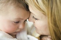 Portrait of mother and baby face to face — Stock Photo