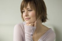 Portrait of smiling woman with short hair looking away — Stock Photo