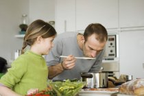 Homem e menina cozinhar na cozinha doméstica — Fotografia de Stock