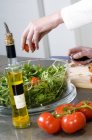 Female hands making salad in kitchen, close-up — Stock Photo
