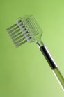 Close-up of plastic lash brush on green background — Stock Photo