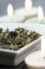 Close-up of Dried mint leaves and candles in spa — Stock Photo