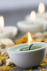 Close-up of lighting candle and dried flowers in spa — Stock Photo