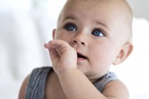 Portrait of thoughtful baby boy with blue eyes — Stock Photo