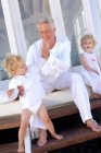 Grandfather and children at home — Stock Photo