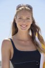 Portrait of smiling elegant woman in swimsuit outdoors — Stock Photo