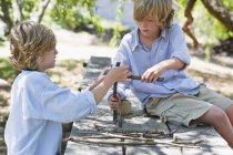 Children making frame of driftwood outdoors — Stock Photo