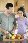 Happy couple cooking in kitchen together — Stock Photo