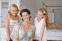 Woman smiling with her two daughters — Stock Photo
