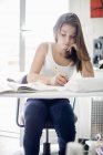 Focused teenage girl studying at desk — Stock Photo