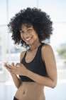 Portrait of smiling sport woman using mobile phone — Stock Photo